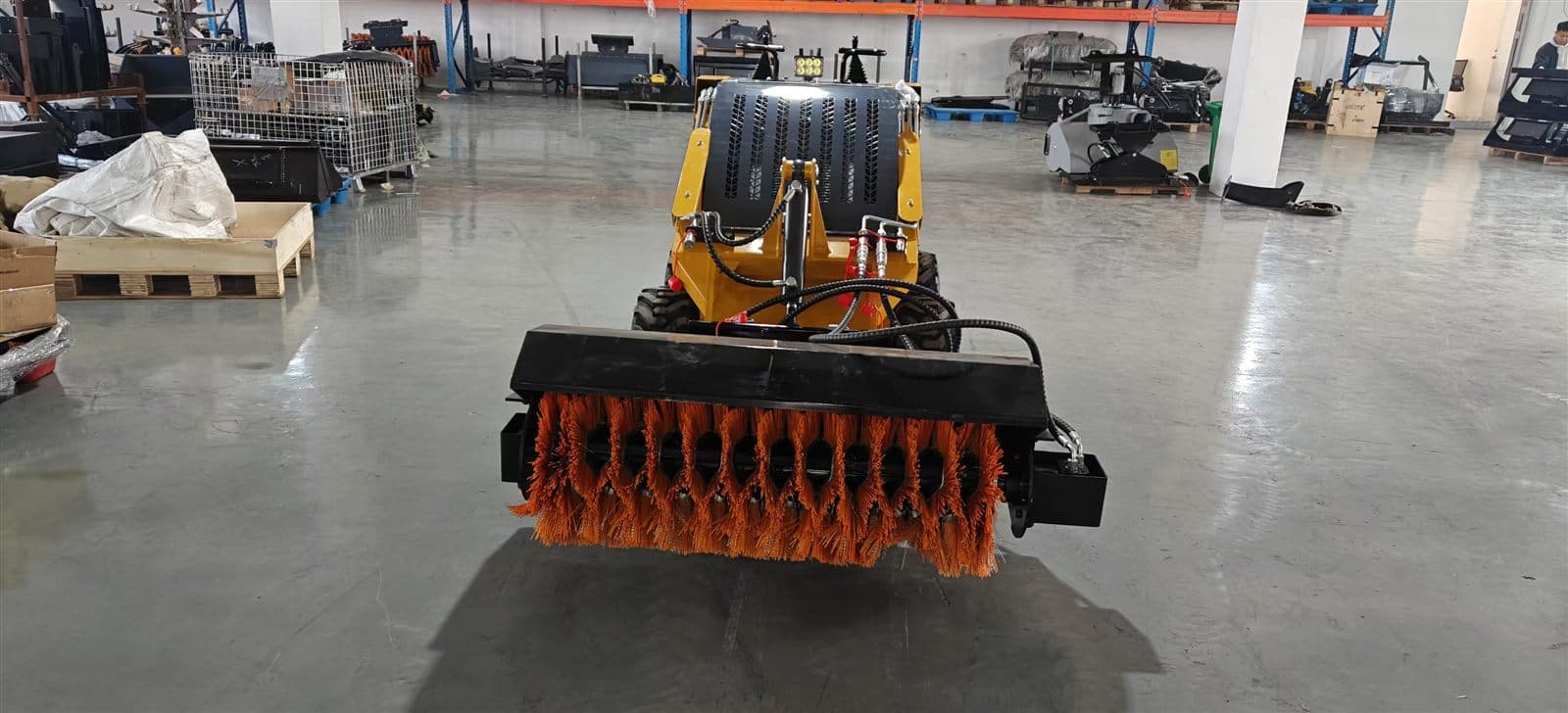Angled sweeper attachment for skid steer loader
