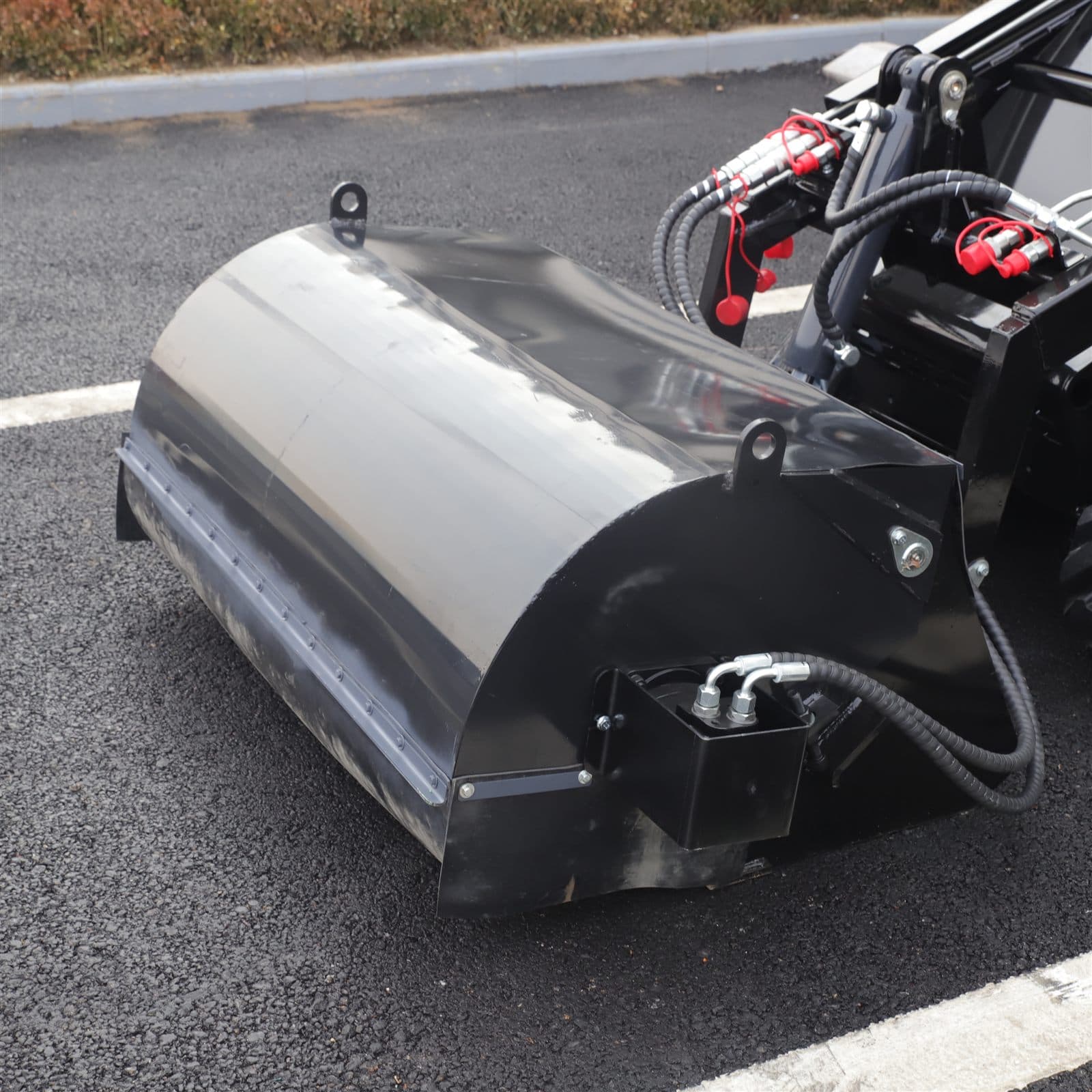 Enclosed sweeper attachment for skid steer loader