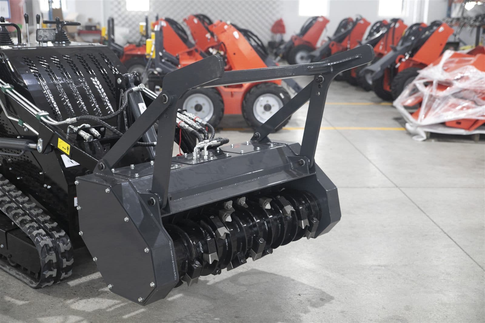 Land clearing attachment for skid steer loader