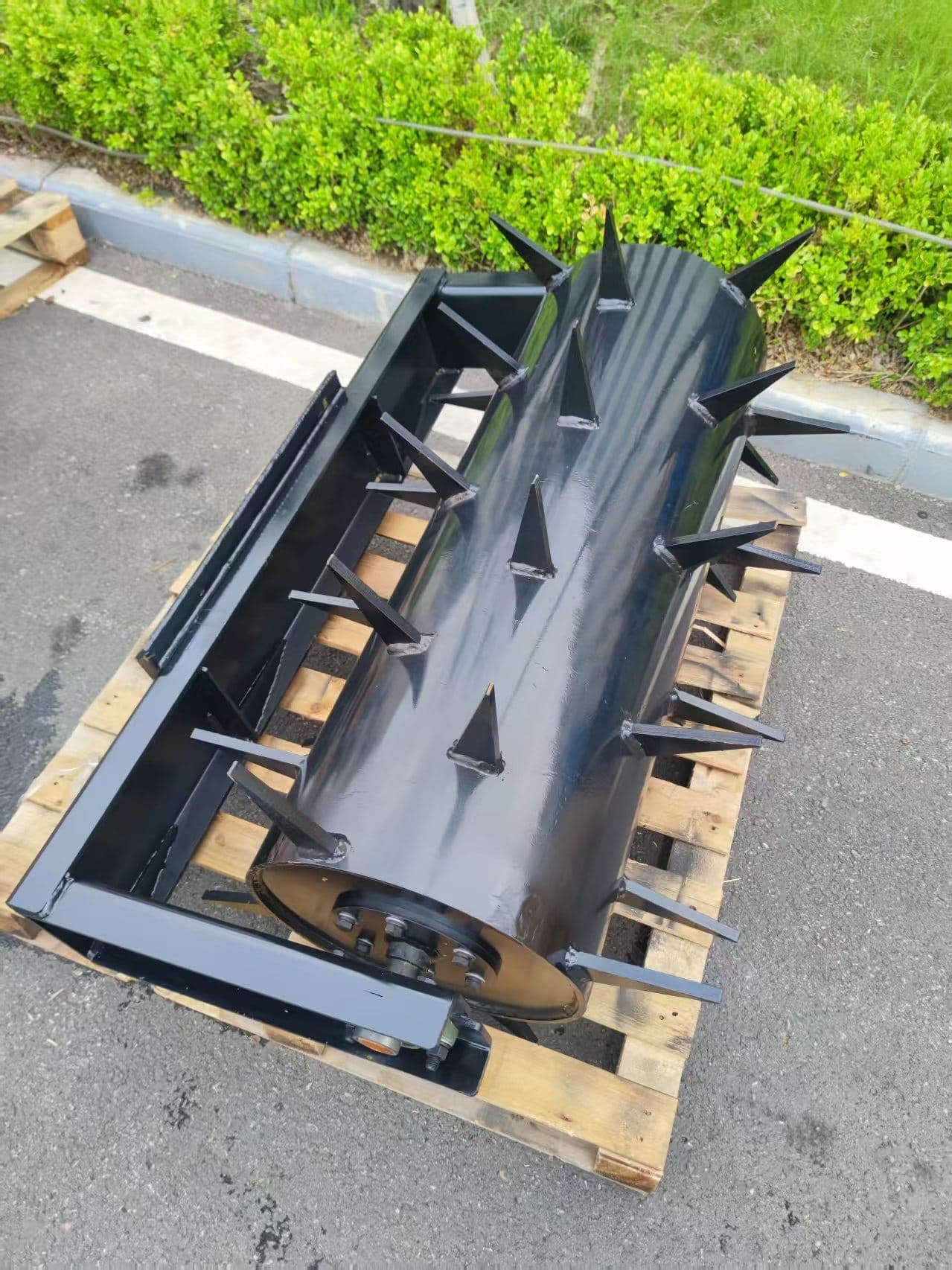 Lawn aerator attachment for skid steer loader
