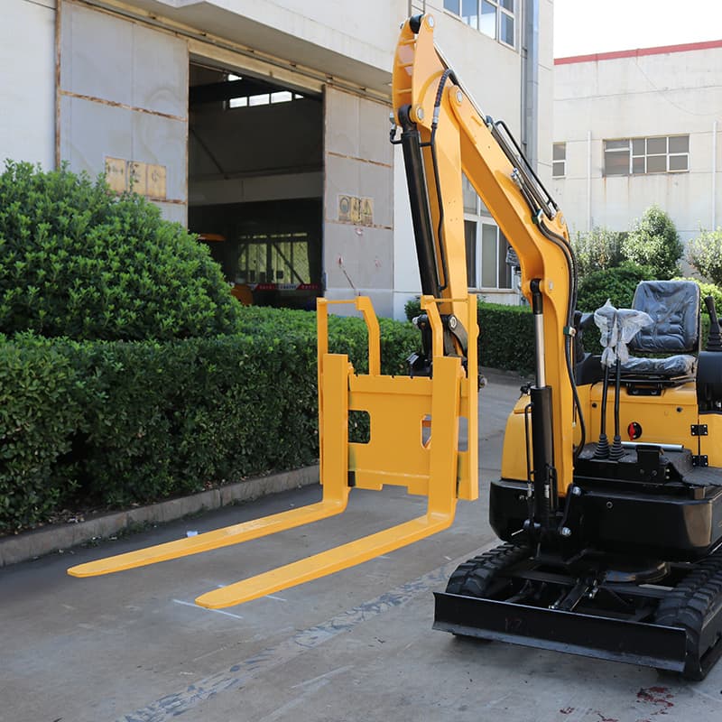 Fork attachment mounted on compact excavator