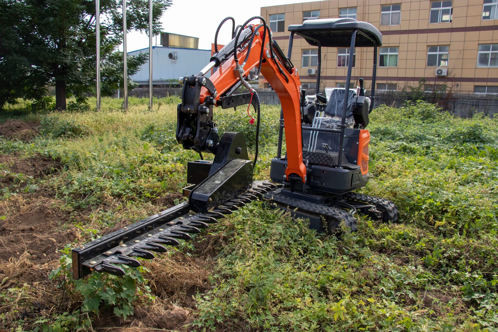 Hedge trimmer mounted on compact excavator
