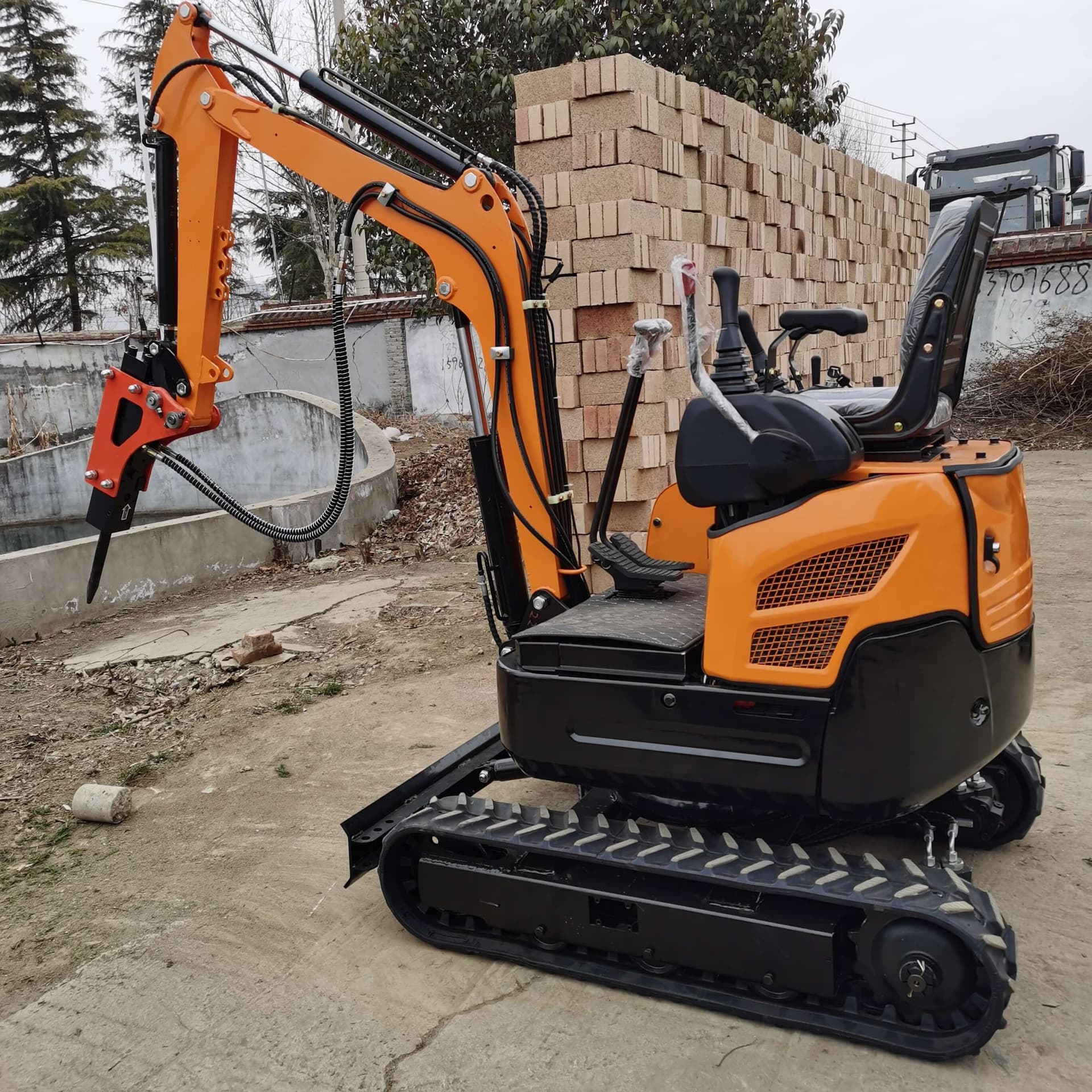 Hydraulic breaker mounted on compact excavator