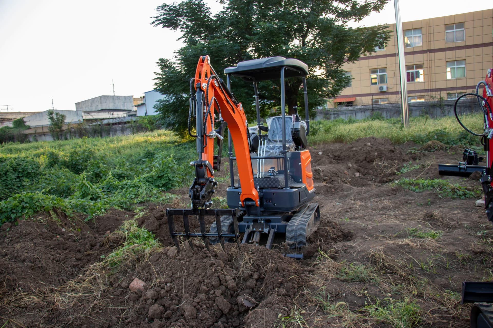 Rake attachment mounted on compact excavator