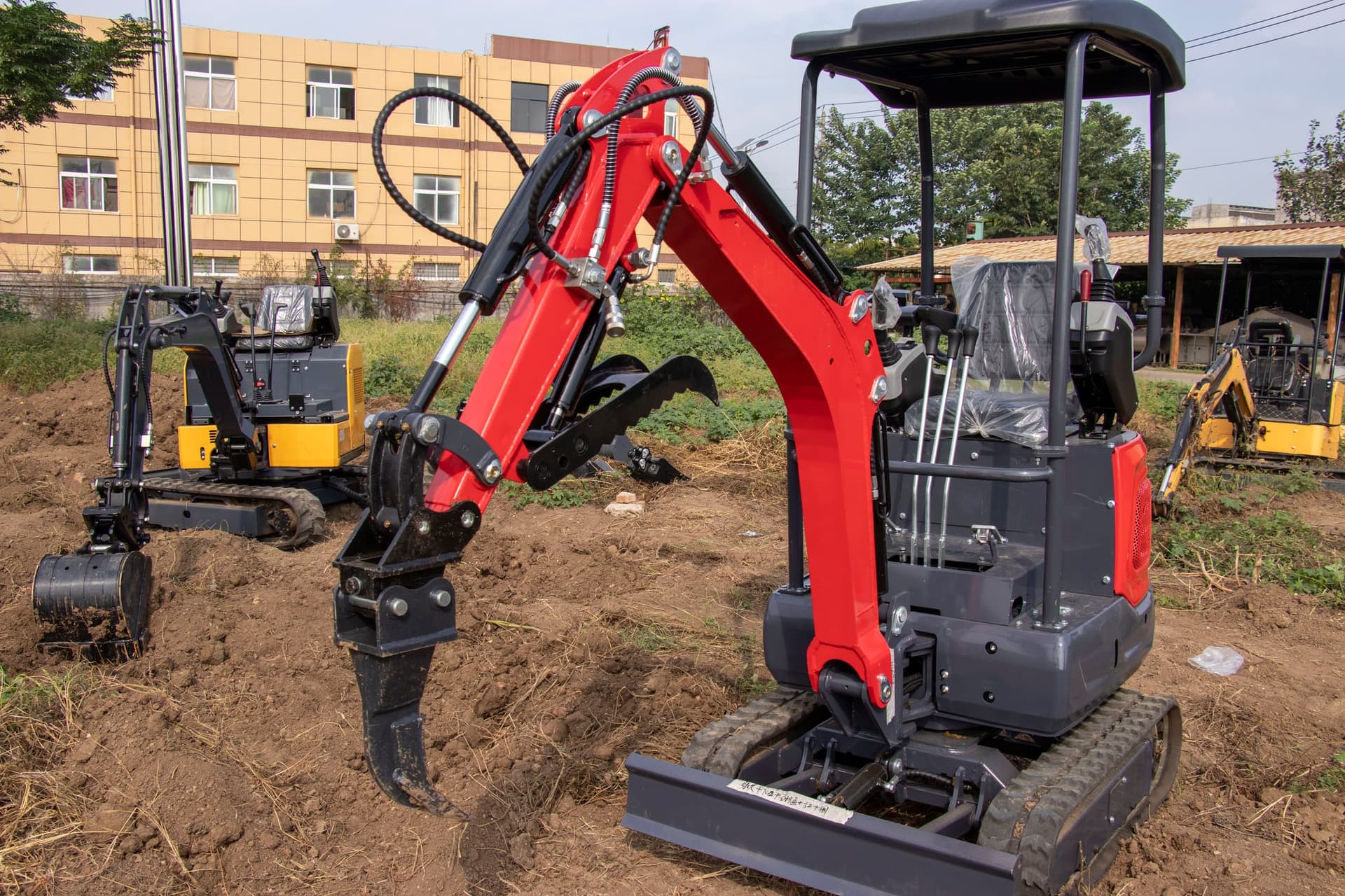 Single-tine ripper mounted on compact excavator