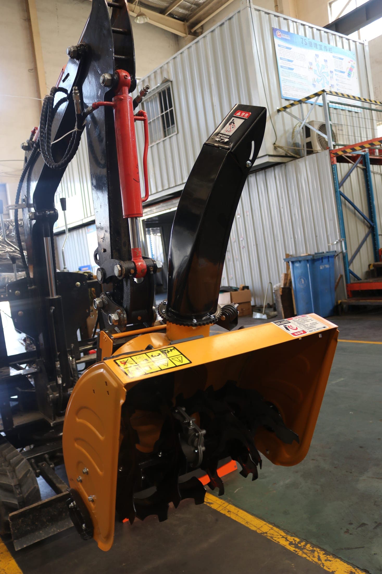 Snow blower mounted on compact excavator