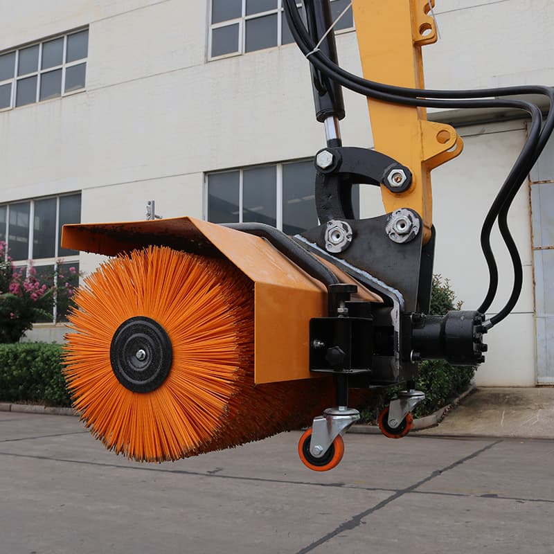 Snow sweeper attachment mounted on compact excavator